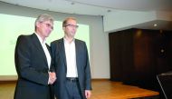 Henri Poupart-Lafarge, Chairman and Chief Executive Officer of Alstom, shakes hands with Siemens President and CEO Joe Kaeser (L) at a news conference to announce their deal to merge their rail operations, creating a European champion, in Paris, France, S