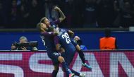 Paris Saint-Germain’s Neymar (centre) is congratulated by team-mates Dani Alves and Kylian Mbappe after he scored a goal during their UEFA Champions League football match against Bayern Munich in Paris yeasterday.