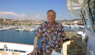 (FILES) This file photo taken on May 12, 2001 shows the US founder and editor-in-chief of Playboy magazine, Hugh Hefner, wearing a shirt with the covers of Playboy magazine on the Esmaralda yatch during the 54th Cannes Film Festival in Cannes, France. AFP