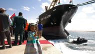 A Libyan girl poses for a photo at the Benghazi port, which was closed for the past three years due to rebel groups occupying the eastern Libyan city, during a ceremony marking the re-opening of the port on October 1, 201. AFP / Abdullah Doma