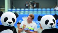 Uzbekistan’s Denis Istomin poses with the trophy after defeating Cyprus’ Marcos Baghdatis during their men’s singles final at the ATP Chengdu Open in Chengdu, yesterday. 