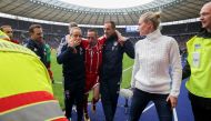 Bayern Munich's French midfielder Franck Ribery (C) is helped off the pitch by medical staff after injuring his knee during the German first division Bundesliga football match between Hertha Berlin and FC Bayern Munich in Berlin, on October 1, 2017.  AFP 