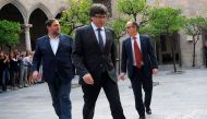 Catalan president Carles Puigdemont (C) arrives with Catalan government spokesman, Jordi Turull (R) and leader of the left-wing party Esquerra Republicana (ERC), Catalan regional vice-president and chief of Economy and Finance Oriol Junqueras (C) for a Ca