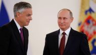 Russian President Vladimir Putin (R) looks at Jon Huntsman, the U.S. new ambassador to Russia, after receiving his diplomatic credentials during a ceremony at the Kremlin in Moscow, Russia October 3, 2017. REUTERS/Pavel Golovkin/Pool