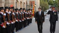 President of the Catalan regional government Carles Puigdemont (2R) and Josep Lluis Trapero (R), chief of the Catalan regional police, inspecting the Mossos D'Esquadra troops before attending an institutional ceremony to award the Mossos d'Esquadra (Catal