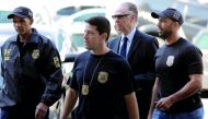 Brazilian Olympic Committee (COB) President Carlos Arthur Nuzman (centre) arrives to Federal Police headquarters in Rio de Janeiro, Brazil yesterday.