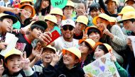 Mercedes’ Lewis Hamilton takes a selfie with local students at the Suzuka Circuit in Suzuka, Japan ahead of the Formula One Japanese Grand Prix yesterday.