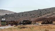 Turkish army armoured vehicles and soldiers wait on October 8, 2017 at Syria-Turkey border at Reyhanli district in Hatay.  AFP / ILYAS AKENGIN
