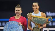 Caroline Garcia of France (R) holds the trophy after winning the women's singles final against Simona Halep of Romania (L) at the China Open tennis tournament in Beijing on October 8, 2017. / AFP / GREG BAKER
