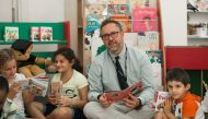 A staff of ACS Doha interacting with students. 