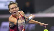 Simona Halep of Romania hits a return during the women's singles final against Caroline Garcia of France at the China Open tennis tournament in Beijing on October 8, 2017. / AFP / GREG BAKER