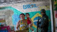 Brazilian army soldiers patrol the Rocinha favela in Rio de Janeiro, Brazil on October 11, 2017. Some 500 soldiers, some in armored vehicles, swept into Rio de Janeiro's Rocinha favela Tuesday to support a police raid after gun fights broke out between ri