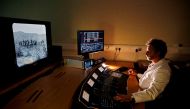 A technician works on a computer to digitally restore individual frames of a film at the British Film Institute (BFI) in Berkhampsted, north of London on October 10, 2017. AFP / ADRIAN DENNIS 
