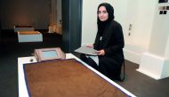 Sidra Sohail with her creation during the opening of the ‘Modern Prayer Rug’ exhibition at the Company House, part of Msheireb Museums in Msheireb Downtown, Doha. Pic: Abdul Basit / The Peninsula