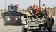 Iraqi forces flash the sign for victory as they advance in the southern outskirts of Kirkuk towards the city during an operation against Kurdish fighters on October 16, 2017.  AFP / AHMAD AL-RUBAYE
