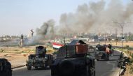 Smoke billows as Iraqi forces advance towards the centre of Kirkuk during an operation against Kurdish fighters on October 16, 2017. AFP / AHMAD AL-RUBAYE
