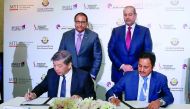 H E Sheikh Ahmed bin Jassim Al Thani (standing right), Minister of Economy and Commerce, and Singapore’s Minister of Trade and Industry, S Iswaran (standing left) witnessing the signing of an MoU between Sheikh Khalifa bin Jassim bin Mohammed Al Thani (si