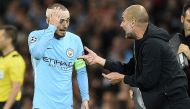 Manchester City's Spanish midfielder David Silva holds his bandaged head as Manchester City's Spanish manager Pep Guardiola gives him instructions during the UEFA Champions League Group F football match between Manchester City and Napoli at the Etihad Sta