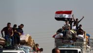 A picture taken on October 18, 2017 shows displaced Iraqis, who fled from Hawija in 2014 to Kirkuk, riding in vehicles as they return to Hawija, after the town was retaken by Iraqi forces. AFP / Ahmad Al-Rubaye