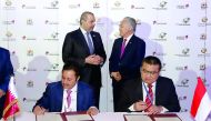 H E Sheikh Ahmed bin Jassim Al Thani (standing left), Minister of Economy and Commerce, and Enggar Lukita (standing right), Indonesian Trade Minister, witnessing the signing of an MoU between Sheikh Khalifa bin Jassim bin Mohammed Al Thani (sitting left),