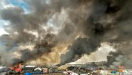 This file photo taken on October 26, 2016 shows smoke rising from a fire over the 