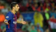 Barcelona's Uruguayan forward Luis Suarez (L) gestures during the UEFA Champions League group D football match FC Barcelona vs Olympiacos FC at the Camp Nou stadium in Barcelona on Ocotber 18, 2017. / AFP / LLUIS GENE