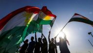 [FIle Photo] Iraqi Kurds wave flags of Iraqi Kurdistan during a demonstration outside the UN Office in Arbil, on October 21, 2017. AFP / SAFIN HAMED
