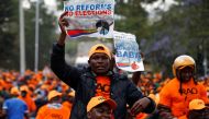 Supporters of Kenyan opposition leader Raila Odinga carry banners during a rally at Uhuru Park in Nairobi, Kenya October 25, 2017. REUTERS/Siegfried Modola