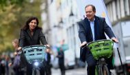 Mayor of Paris Anne Hidalgo (L) and President of Paris Metropole Patrick Oller ride new 