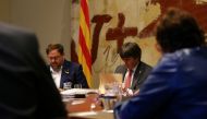Catalan President Carles Puigdemont (R) and Vice President Oriol Junqueras read documents during a cabinet meeting at Generalitat Palace in Barcelona, Spain, October 24, 2017. Reuters/Ivan Alvarado