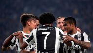 Juventus' Colombian forward Juan Cuadrado (C) celebrates with Juventus' Argentinian forward Paulo Dybala (L) and Juventu's Brazilian forward Douglas Costa de Souza after scoring during the Italian Serie A football match Juventus vs Spal at the Allianz sta