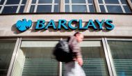 (FILES) This file photo taken on October 22, 2017 shows a pedestrian walking past a branch of Barclays bank in central London.  AFP / Tolga Akmen
