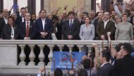 Catala president Carles Puigdemont (C), vice president Oriol Junqueras (L) and president of the Parliament Carme Forcadell (R) sing the Catalan anthem 