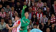 Barcelona's German goalkeeper Marc-Andre ter Stegen (C) vies with Athletic Bilbao's French defender Aymeric Laporte (L) during the Spanish league football match Athletic Club Bilbao vs FC Barcelona at the San Mames stadium in Bilbao on October 28, 2017. /