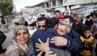Relatives hug one of the hostages held by Islamic State militants who escaped from his captors in Qaryatayn town in Homs province, Syria October 29, 2017. Reuters/Omar Sanadiki