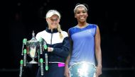Denmark’s Caroline Wozniacki celebrates with the trophy after winning the final against USA’s Venus Williams in Singapore yesterday.