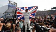 Mercedes' British driver Lewis Hamilton celebrates after winning his fourth Formula One world title despite finishing the Mexican Grand Prix in ninth place, at the Hermanos Rodriguez circuit in Mexico City on October 29, 2017. / AFP / Alfredo ESTRELLA