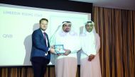 Yousef Ali Darwish (centre), General Manager-Group Communications, QNB, receiving the award at the event.