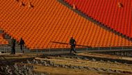 In a photo taken on Oct 27, 2017 workers carry materials at the stadium of the Pyeongchang Winter Olympics 2018 opening ceremony, in Pyeongchang. (Photo: AFP/ Sebastien Berger).