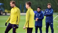 Tottenham Hotspur's Argentinian head coach Mauricio Pochettino (R) stands with assistant manager Jesus Perez (2R) during a training session at Tottenham Hotspur's Enfield Training Centre, north-east of London, on October 31, 2017 on the eve of their UEFA 