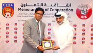 Sheikh Hamad bin Khalifa bin Ahmed Al Thani, President of the QFA hands a memento to  Anura De Silva, President of the Football Federation of Sri Lanka (FFSL) yesterday.