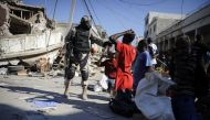 (FILES) This file photo taken on January 15, 2010 shows a Haitian policeman arresting looters on a street of Port-au-Prince, three days after an earthquake measuring 7.0 on the open-ended Richter scale hit the Haitian capital. AFP / Olivier Laban-Mattei 