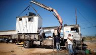 A container, which was used by Hamas security forces, is removed at Erez crossing, in the northern Gaza Strip November 1, 2017. (Reuters/Mohammed Salem)