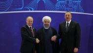 Russian President Vladimir Putin (L), Iranian President Hassan Rouhani (C) and Azerbaijani President Ilham Aliyev (R) pose for a photo during the 2nd trilateral summit between Iran, Russia and Azerbaijan in Tehran, Iran on November 01, 2017. (Iranian Pres