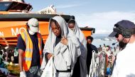 FILE PHOTO: This handout picture taken and released by the Italian Red Cross on October 22, 2016 shows migrants landing in Vibo Marina, after a rescue operation in the Mediterranean Sea (AFP) 