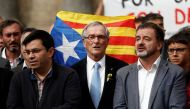Former Barcelona's mayor Xavier Trias (C) stands in front of an Estelada (Catalan separatist flag) as he gathers at Sant Jaume square to demand the freedom of the leaders of two of the largest Catalan separatist organizations, Catalan National Assembly's 