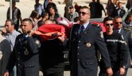 Tunisian policemen take part in a symbolic funeral on November 3, 2017 in the city of Sfax during a march in solidarity with a policeman who died a day earlier after he was stabbed outside parliament in the capital Tunis. AFP / Houssem Zouari