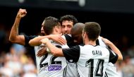 Valencia's Spanish forward Santiago Mina Lorenzo (2L) celebrates a goal with teammates during the Spanish league footbal match Valencia CF vs Club Deportivo Leganes SAD at the Mestalla stadium in Valencia on November 4, 2017. (AFP / JOSE JORDAN)