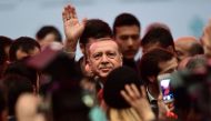 Turkish President Recep Tayyip Erdogan (C) waves to supporters on November 6, 2017 during the launch of a project to built a new opera house in Istanbul.   AFP / OZAN KOSE
