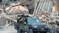 Syrian pro-government forces patrol in the eastern city of Deir Ezzor on November 4, 2017. Syrian and allied forces converged on holdout Islamic State group fighters in the Syrian border town of Albu Kamal, the jihadists' very last urban bastion following